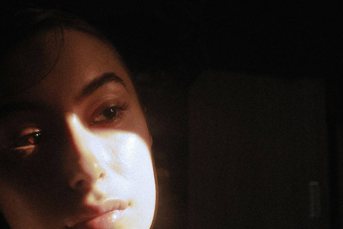 Woman applying serum as part of glow routine glowing skin night care before bed
